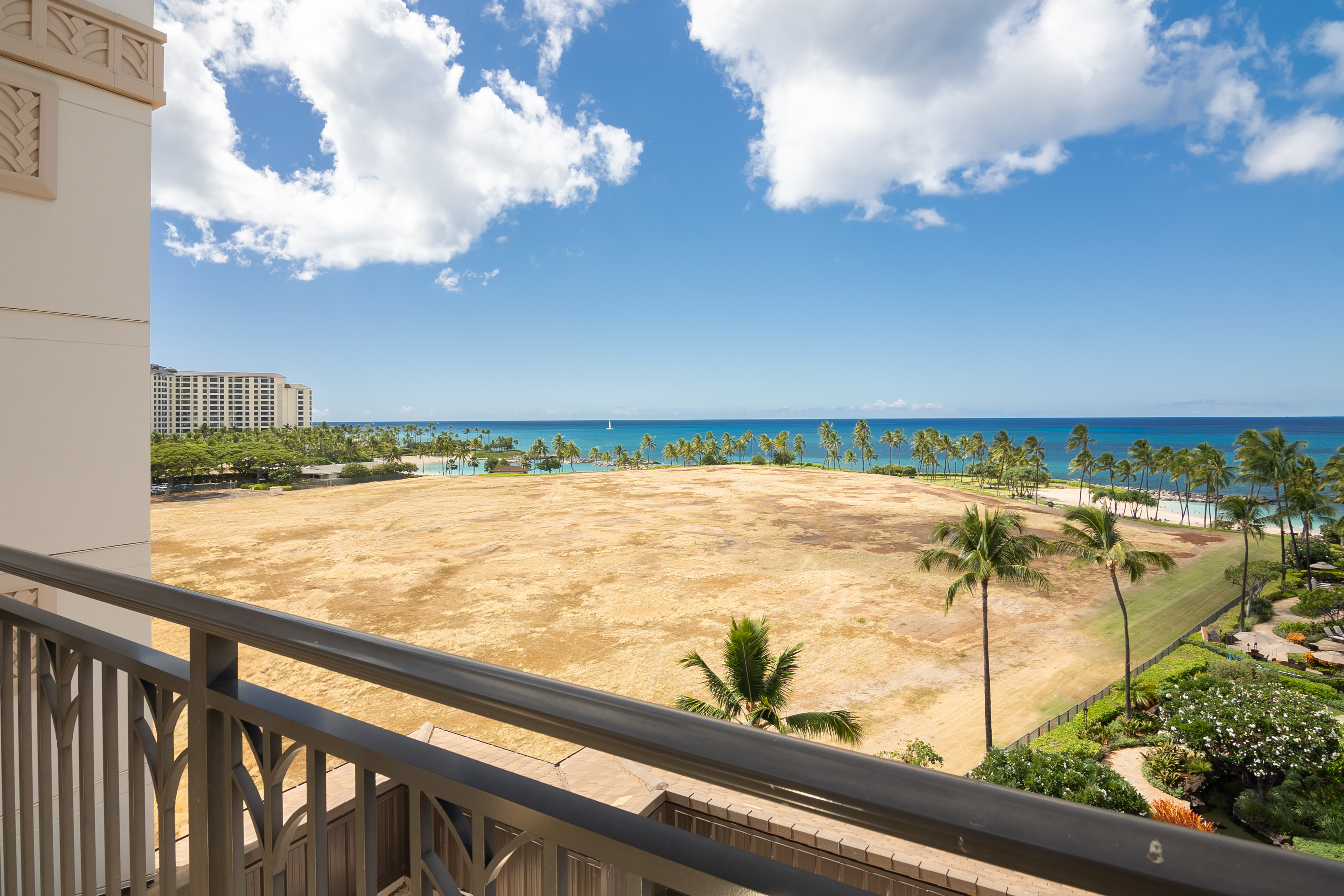 Wide ocean view from the condo lanai across the open parcel beside the resort
