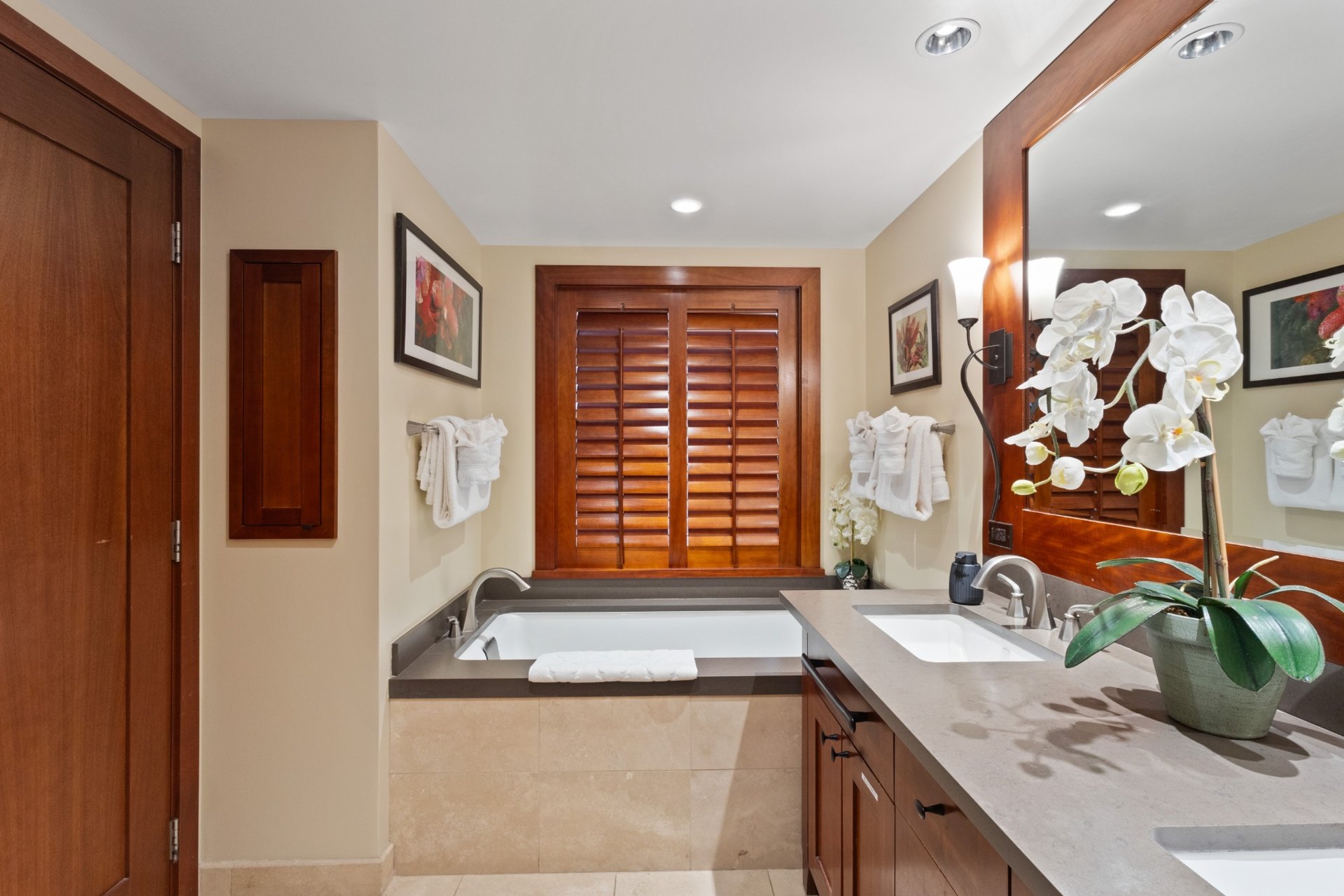 Primary bathroom with bathtub and vanity